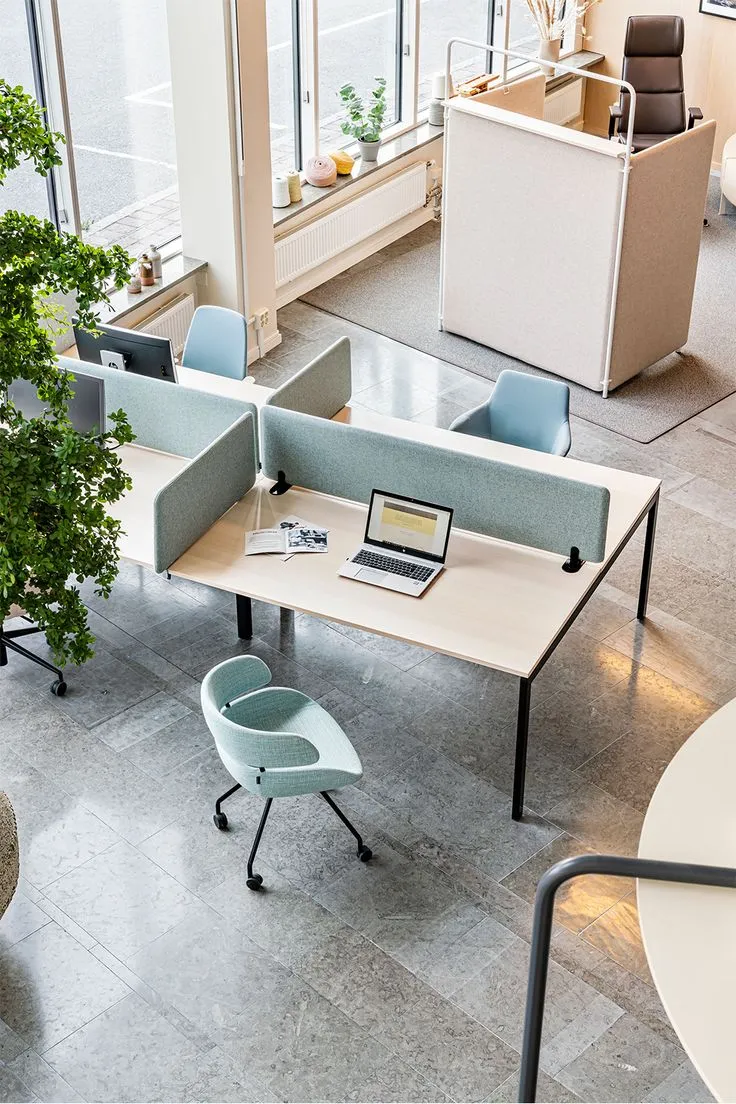 Modern office desk setup with monitor and chair